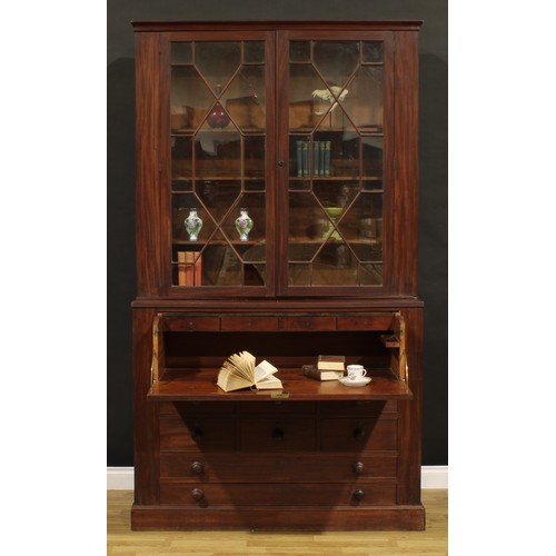 1345 - A Post-Regency mahogany secretaire library bookcase, outswept cornice above a pair of doors enclosin... 