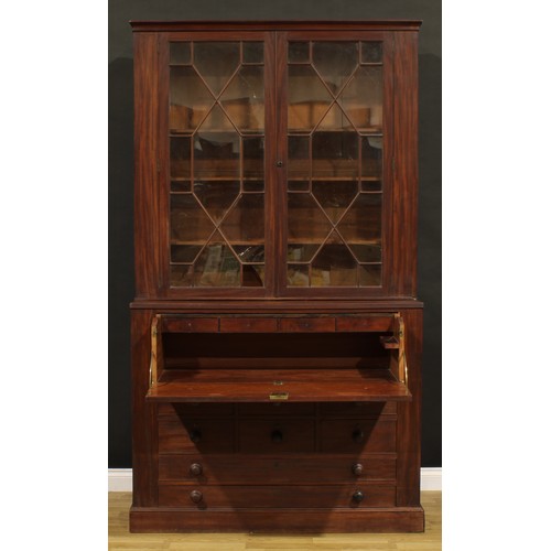 1345 - A Post-Regency mahogany secretaire library bookcase, outswept cornice above a pair of doors enclosin... 