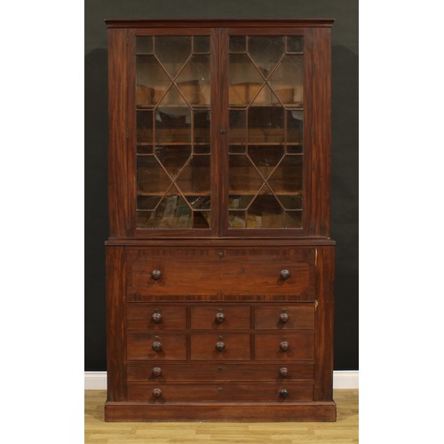 1345 - A Post-Regency mahogany secretaire library bookcase, outswept cornice above a pair of doors enclosin... 