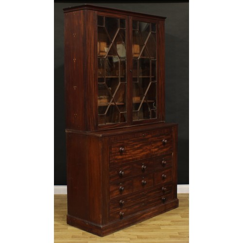 1345 - A Post-Regency mahogany secretaire library bookcase, outswept cornice above a pair of doors enclosin... 