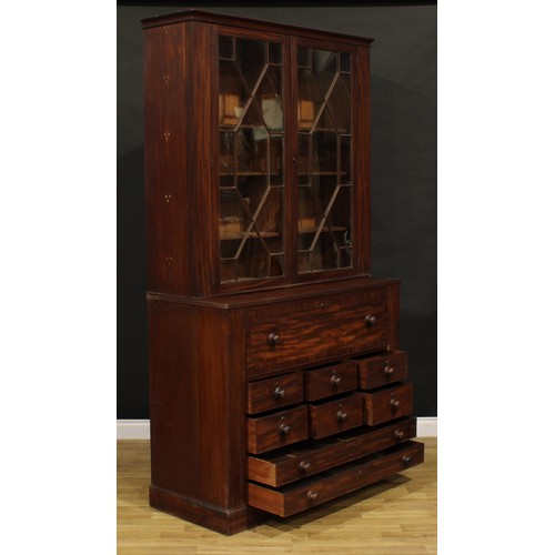 1345 - A Post-Regency mahogany secretaire library bookcase, outswept cornice above a pair of doors enclosin... 