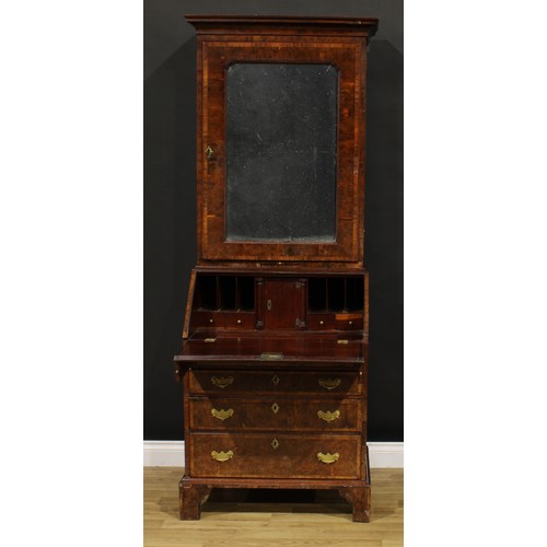 1361 - An 18th century burr yew bureau book cabinet, moulded cornice above a mirrored door enclosing a shel... 