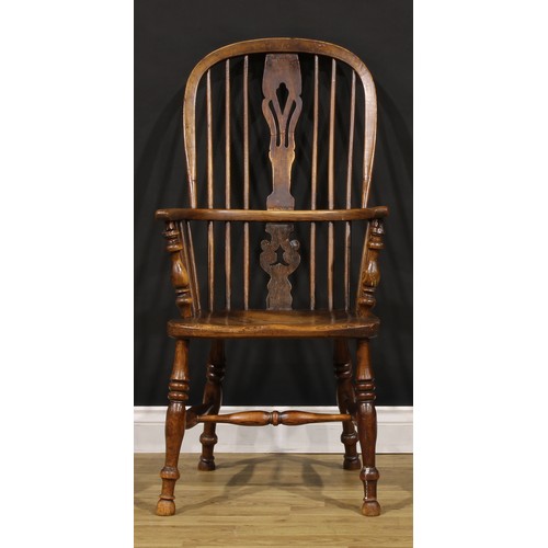 1379 - A 19th century East Midlands ash and elm Windsor elbow chair, hoop back, shaped and pierced splat, s... 