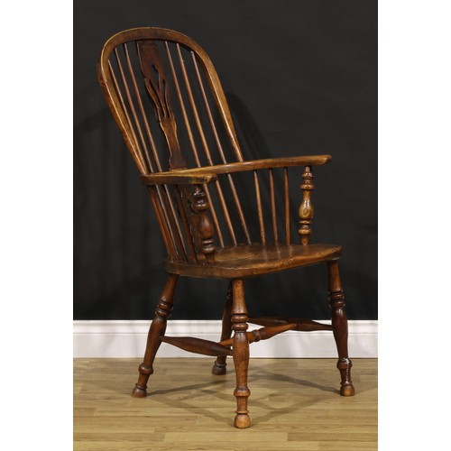 1379 - A 19th century East Midlands ash and elm Windsor elbow chair, hoop back, shaped and pierced splat, s... 