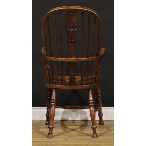 1379 - A 19th century East Midlands ash and elm Windsor elbow chair, hoop back, shaped and pierced splat, s... 