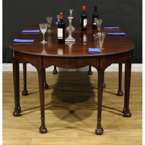 1394 - A 19th century mahogany D-end dining table, possibly Irish, slightly oversailing top above a deep fr... 