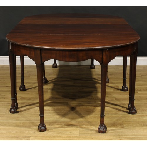 1394 - A 19th century mahogany D-end dining table, possibly Irish, slightly oversailing top above a deep fr... 