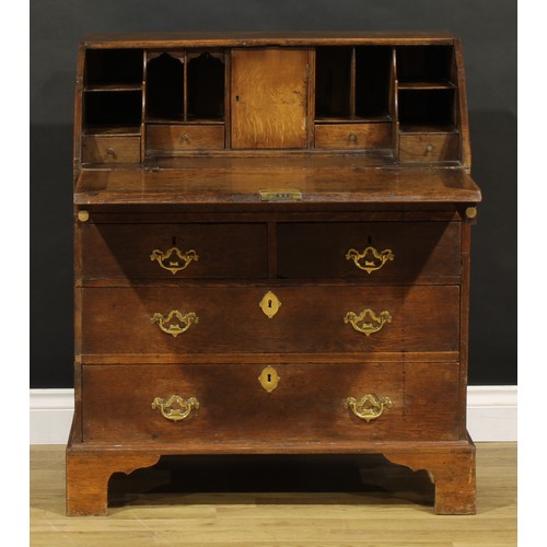 1188 - A George III oak bureau, fall front enclosing a well, a small door, small drawers and pigeonholes, a... 