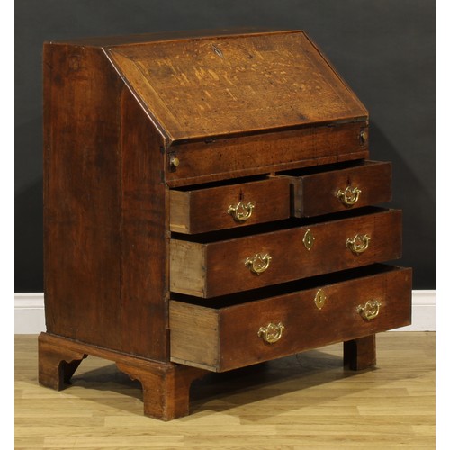 1188 - A George III oak bureau, fall front enclosing a well, a small door, small drawers and pigeonholes, a... 