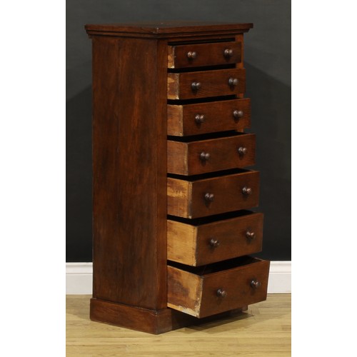 1198 - A late Victorian oak veneered Wellington chest, oversailing rectangular top above seven drawers, pli... 