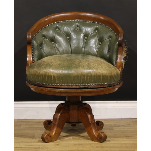 1338 - A late Victorian Arts & Crafts period oak swivel desk chair, by Alexandre Dubois, stuffed-over uphol... 