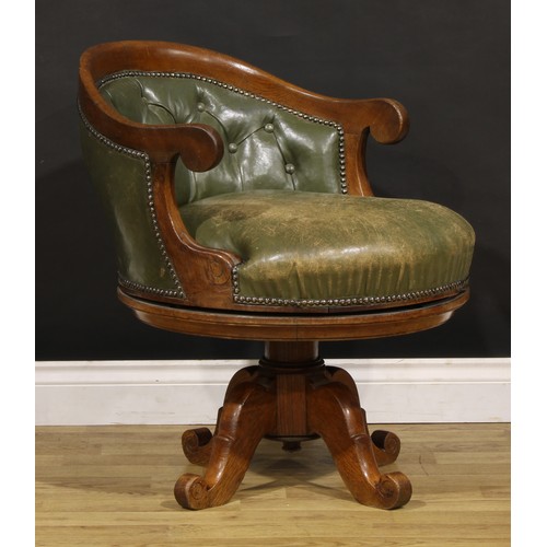 1338 - A late Victorian Arts & Crafts period oak swivel desk chair, by Alexandre Dubois, stuffed-over uphol... 