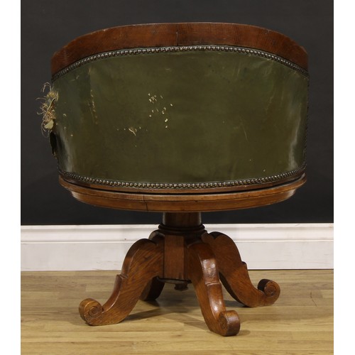 1338 - A late Victorian Arts & Crafts period oak swivel desk chair, by Alexandre Dubois, stuffed-over uphol... 