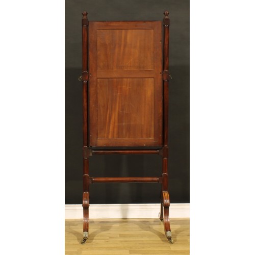 1424 - A Regency mahogany cheval mirror, bevelled plate, moulded frame, turned finials, hipped sabre legs, ... 