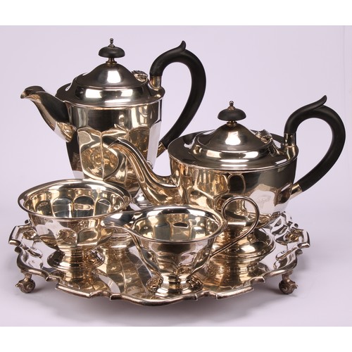 602 - A composed silver four piece tea service, Edward Viner, Sheffield 1930/1938; a silver shaped circula... 