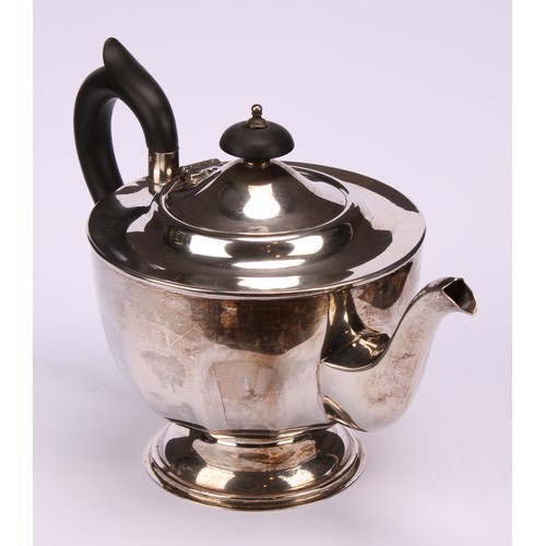 602 - A composed silver four piece tea service, Edward Viner, Sheffield 1930/1938; a silver shaped circula... 