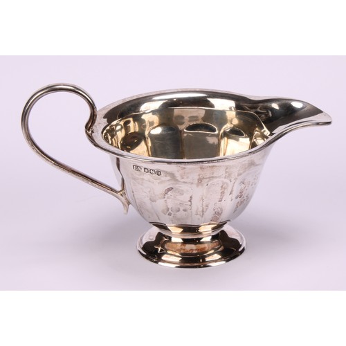 602 - A composed silver four piece tea service, Edward Viner, Sheffield 1930/1938; a silver shaped circula... 