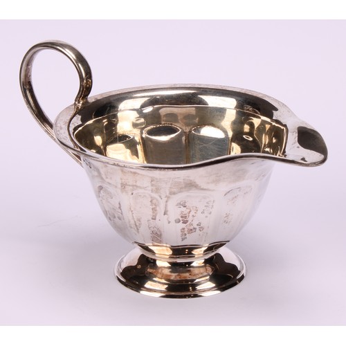 602 - A composed silver four piece tea service, Edward Viner, Sheffield 1930/1938; a silver shaped circula... 