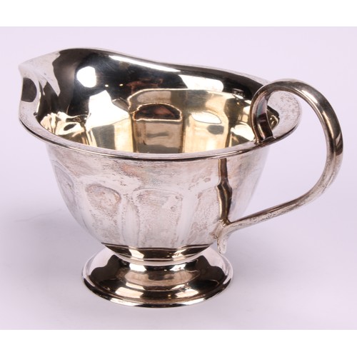 602 - A composed silver four piece tea service, Edward Viner, Sheffield 1930/1938; a silver shaped circula... 