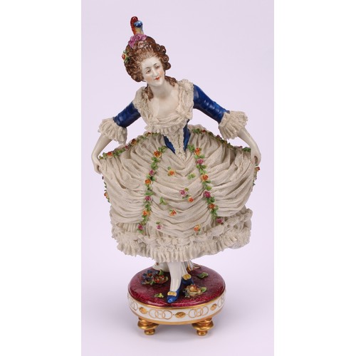 137 - A late 19th German porcelain figure, of a female curtsying, wearing a lace dress encrusted with flow... 