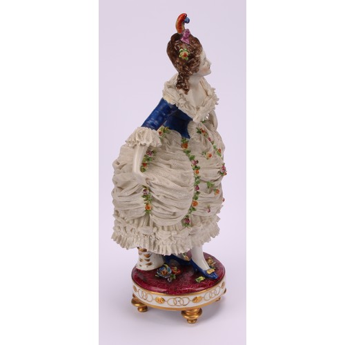 137 - A late 19th German porcelain figure, of a female curtsying, wearing a lace dress encrusted with flow... 