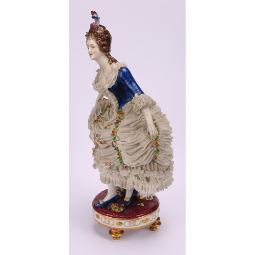 137 - A late 19th German porcelain figure, of a female curtsying, wearing a lace dress encrusted with flow... 