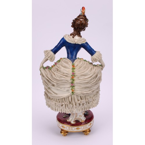 137 - A late 19th German porcelain figure, of a female curtsying, wearing a lace dress encrusted with flow... 