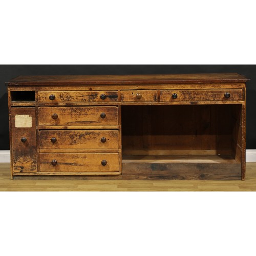 1438 - A Victorian mahogany and pine haberdashery shop counter, rectangular top above an arrangement of dra... 