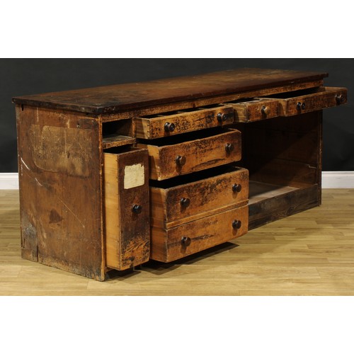 1438 - A Victorian mahogany and pine haberdashery shop counter, rectangular top above an arrangement of dra... 