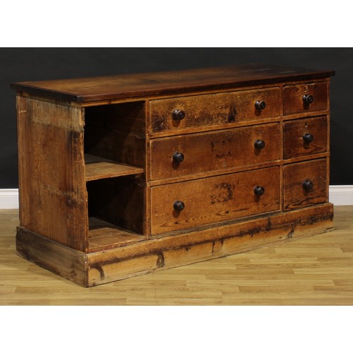 1437 - A Victorian mahogany and pine haberdashery shop counter, rectangular top above an arrangement of dra... 