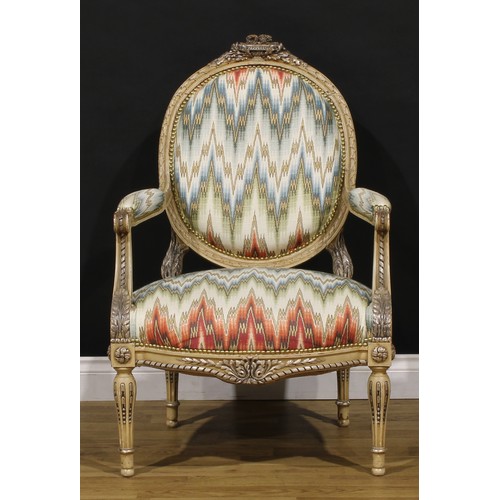 1278 - A pair of Louis XVI Revival painted fauteuils or open armchairs, each cresting carved and applied wi... 