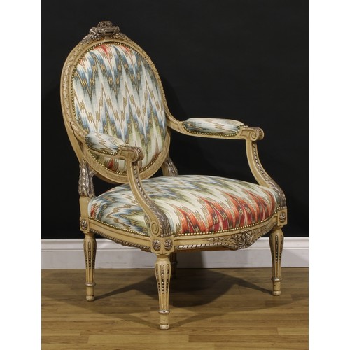 1278 - A pair of Louis XVI Revival painted fauteuils or open armchairs, each cresting carved and applied wi... 