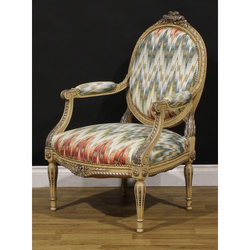 1278 - A pair of Louis XVI Revival painted fauteuils or open armchairs, each cresting carved and applied wi... 