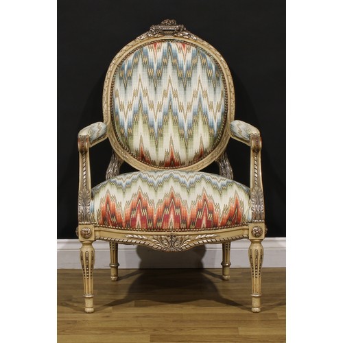 1278 - A pair of Louis XVI Revival painted fauteuils or open armchairs, each cresting carved and applied wi... 