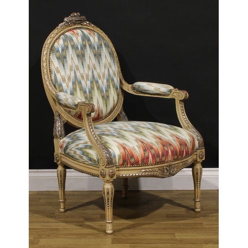 1278 - A pair of Louis XVI Revival painted fauteuils or open armchairs, each cresting carved and applied wi... 