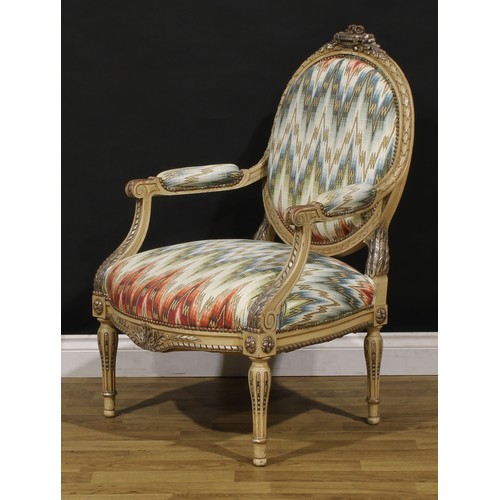 1278 - A pair of Louis XVI Revival painted fauteuils or open armchairs, each cresting carved and applied wi... 