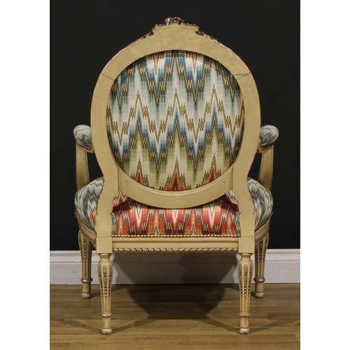 1278 - A pair of Louis XVI Revival painted fauteuils or open armchairs, each cresting carved and applied wi... 