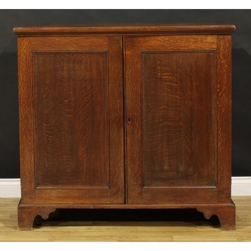 1195 - A George III oak low housekeeper’s cupboard or press cabinet, rectangular top above a pair of panel ... 