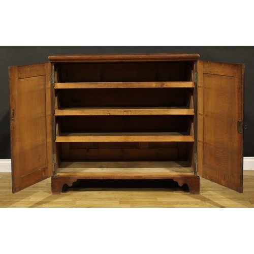 1195 - A George III oak low housekeeper’s cupboard or press cabinet, rectangular top above a pair of panel ... 