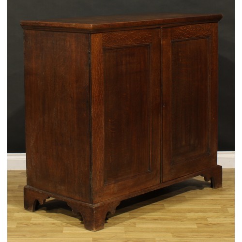 1195 - A George III oak low housekeeper’s cupboard or press cabinet, rectangular top above a pair of panel ... 