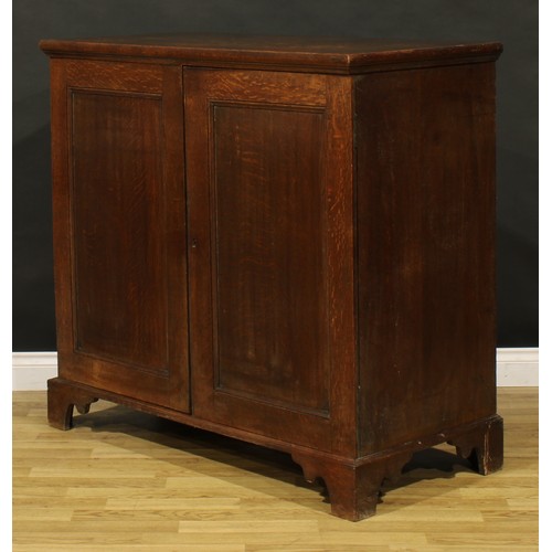 1195 - A George III oak low housekeeper’s cupboard or press cabinet, rectangular top above a pair of panel ... 