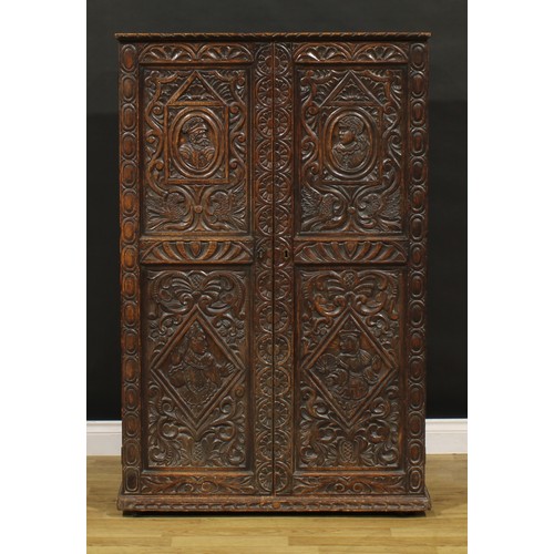 1333 - A late 19th century oak provision cupboard, of neat domestic proportions, carved throughout in the 1... 