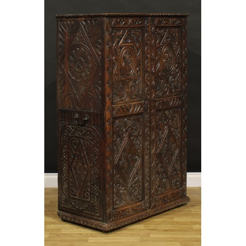 1333 - A late 19th century oak provision cupboard, of neat domestic proportions, carved throughout in the 1... 