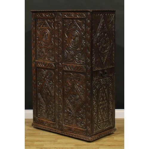 1333 - A late 19th century oak provision cupboard, of neat domestic proportions, carved throughout in the 1... 