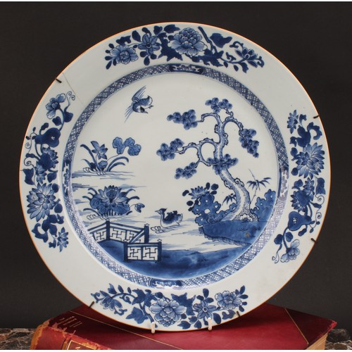 271 - An 18th century Chinese circular charger, painted in tones of underglaze blue with crested grebes in... 