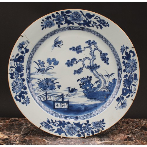 271 - An 18th century Chinese circular charger, painted in tones of underglaze blue with crested grebes in... 