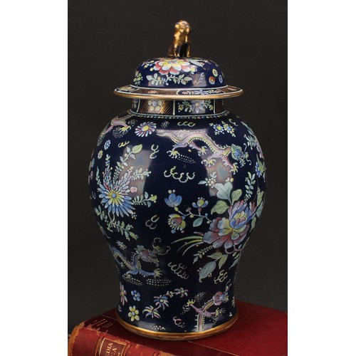 197 - A 19th century Chinese temple jar and cover, decorated in polychrome enamels with dragons amongst fl... 