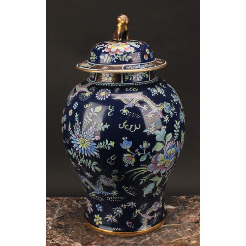 197 - A 19th century Chinese temple jar and cover, decorated in polychrome enamels with dragons amongst fl... 