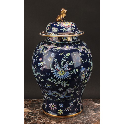 197 - A 19th century Chinese temple jar and cover, decorated in polychrome enamels with dragons amongst fl... 