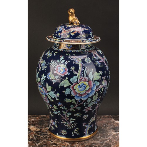 197 - A 19th century Chinese temple jar and cover, decorated in polychrome enamels with dragons amongst fl... 